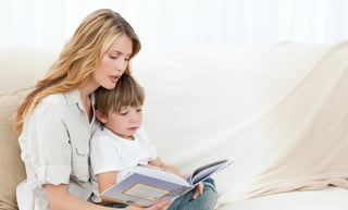 Mother reading with her son on the sofa.jpeg